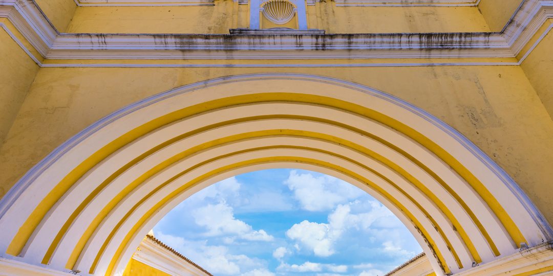 View looking up through the yellow Santa Catalina Arch in Antigua Guatemala