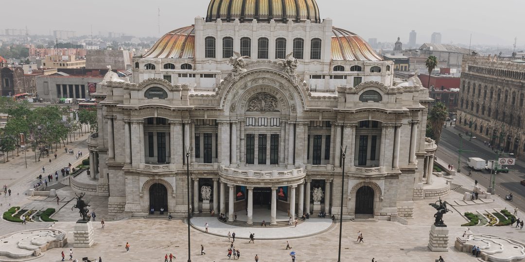 Aerial view of the ornate white and gold dome of the Palacio de Bellas Artes in Mexico City