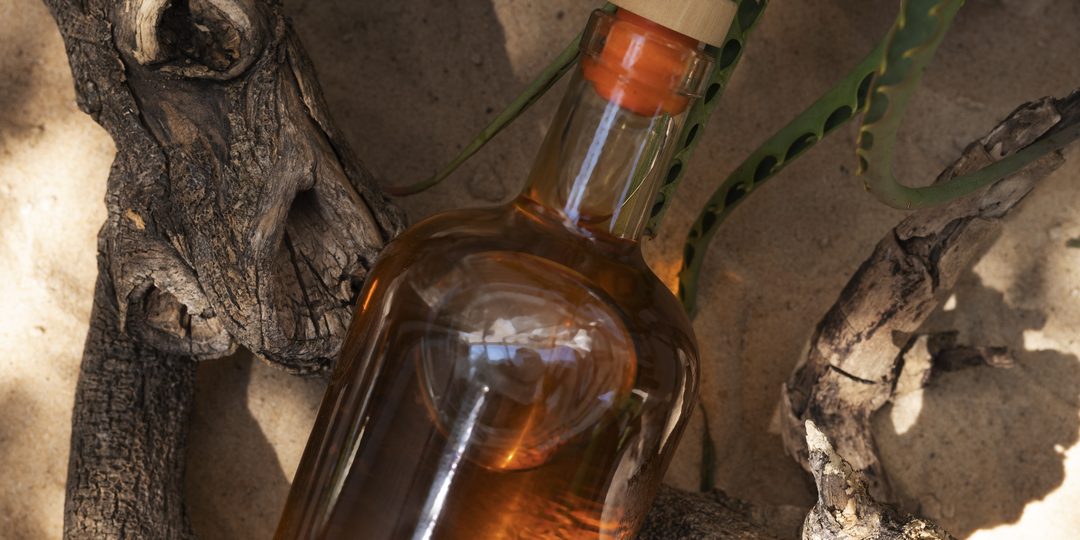 Bottle of rum in a tropical setting