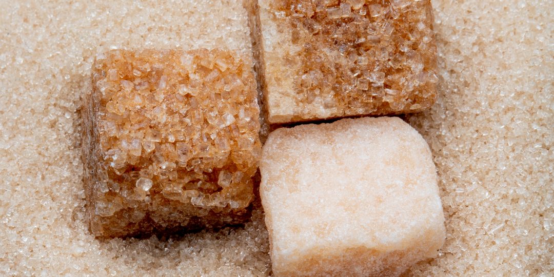 Close-up of raw brown and white sugar cubes