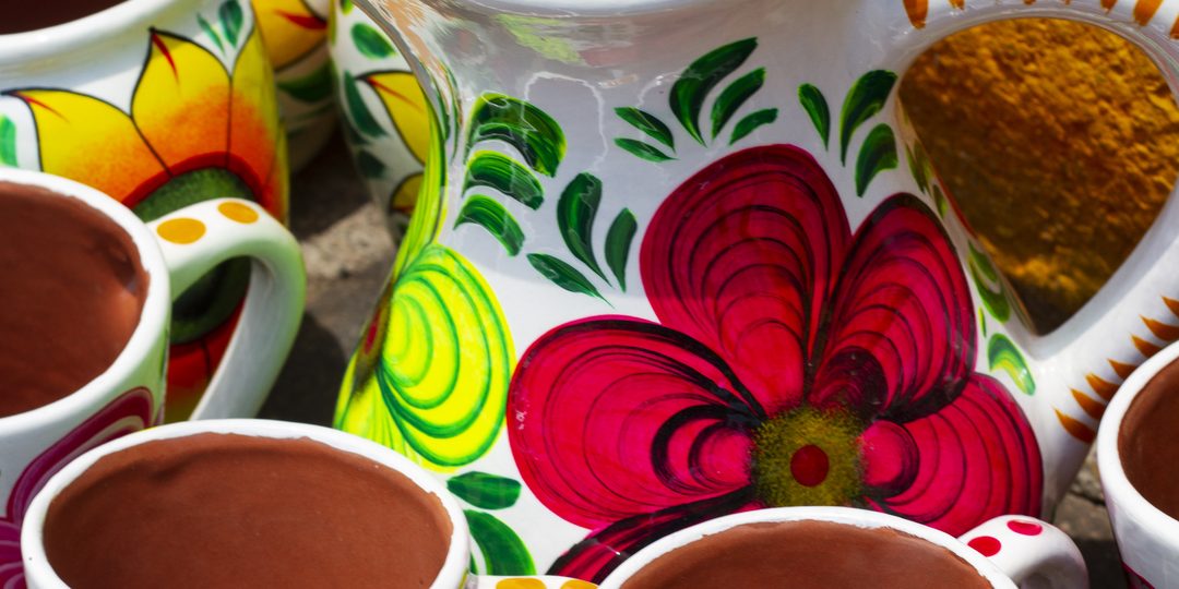Close-up of colorful hand-painted Mexican ceramic mugs with floral designs