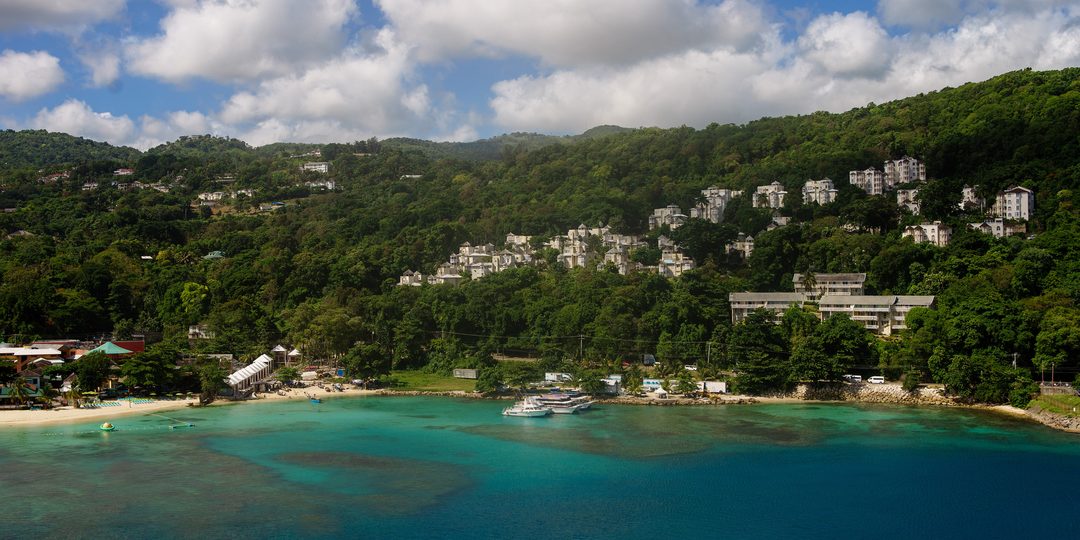Aerial view of the harbor and hillside resorts of Ocho Rios, Jamaica, with turquoise water and green hills